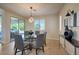Elegant dining room featuring modern lighting, stylish furnishings, and seamless indoor-outdoor living at 8126 Majestic Bighorn St, Las Vegas, NV 89166