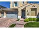 Charming home featuring a three-car garage, arched entryway, and manicured landscaping at 8126 Majestic Bighorn St, Las Vegas, NV 89166
