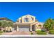 Charming two-story home with a three-car garage, beautiful landscaping, and brick paved driveway at 8126 Majestic Bighorn St, Las Vegas, NV 89166