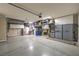 Spacious garage featuring epoxy flooring, ample storage cabinets, and overhead storage racks for optimal organization at 8126 Majestic Bighorn St, Las Vegas, NV 89166