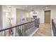 Upstairs hallway with hardwood floors, iron railings, and a view of the entryway at 8126 Majestic Bighorn St, Las Vegas, NV 89166