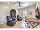 Comfortable home office with a ceiling fan, hardwood floors, and large screen TV at 8126 Majestic Bighorn St, Las Vegas, NV 89166