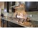 Well-equipped kitchen featuring granite countertops, stainless steel appliances, and tile backsplash at 8126 Majestic Bighorn St, Las Vegas, NV 89166