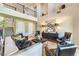 Living room with hardwood floors, soaring ceilings, comfortable seating, and view of second-floor catwalk at 8126 Majestic Bighorn St, Las Vegas, NV 89166