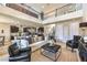 Bright living room with hardwood floors, soaring ceilings, upper floor catwalk, and comfortable seating arrangement at 8126 Majestic Bighorn St, Las Vegas, NV 89166