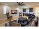 Open living space featuring stylish furnishings, a wet bar, and a large decorative ceiling fan at 8126 Majestic Bighorn St, Las Vegas, NV 89166