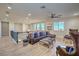 Upstairs loft area featuring hardwood floors, a large sectional, and plenty of natural light at 8126 Majestic Bighorn St, Las Vegas, NV 89166