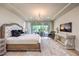 Spacious main bedroom with chandelier, backyard views, and tray ceiling at 8126 Majestic Bighorn St, Las Vegas, NV 89166