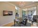 Stylish office space with a chandelier, statement desk, and sliding glass doors to the patio at 8126 Majestic Bighorn St, Las Vegas, NV 89166