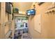 Organized pantry with shelving, cleaning supplies, a television, and a pet bed at 8126 Majestic Bighorn St, Las Vegas, NV 89166