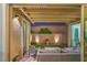 Cozy covered patio with brick flooring, ample seating, and a view of the landscaped backyard at 8126 Majestic Bighorn St, Las Vegas, NV 89166