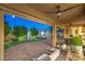 Charming covered patio with brick pavers, ceiling fan, and outdoor mini-golf putting green at 8126 Majestic Bighorn St, Las Vegas, NV 89166