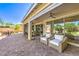 Elegant outdoor living space with comfortable seating, covered patio, and brick pavers at 8126 Majestic Bighorn St, Las Vegas, NV 89166