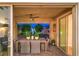 Inviting covered patio with ceiling fan and dining table that overlooks a manicured backyard with water feature at 8126 Majestic Bighorn St, Las Vegas, NV 89166