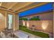 Inviting covered patio with brick flooring and artificial turf, perfect for outdoor relaxation and entertainment at 8126 Majestic Bighorn St, Las Vegas, NV 89166