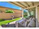 Lovely covered patio with an outdoor seating area overlooking a small grassy yard at 8126 Majestic Bighorn St, Las Vegas, NV 89166