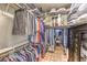 Well-organized walk-in closet with shelving, rods, and a cabinet for optimal storage at 8126 Majestic Bighorn St, Las Vegas, NV 89166
