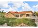 Expansive backyard with covered patio, lush lawn, mature trees, and ample space for activities at 8316 Vibrant Dr, Las Vegas, NV 89117