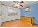 Cozy bedroom with laminate floors, blue accent wall, and ample natural light at 8316 Vibrant Dr, Las Vegas, NV 89117