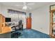 Carpeted bedroom featuring a desk, chair, and storage space near a window at 8316 Vibrant Dr, Las Vegas, NV 89117