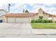 Charming single-story home with a well-manicured lawn, three-car garage, and solar panels at 8316 Vibrant Dr, Las Vegas, NV 89117