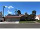Charming single-story home featuring a two-car garage, tile roof, solar panels and well-manicured lawn at 8316 Vibrant Dr, Las Vegas, NV 89117