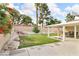 Inviting backyard area with a covered patio, well-maintained lawn, and rock garden at 8316 Vibrant Dr, Las Vegas, NV 89117