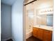 A well-lit bathroom features a double sink vanity, a bathtub with shower, and neutral tile flooring at 9526 Borough Park St, Las Vegas, NV 89178