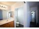 A bathroom with a single sink vanity, toilet, and a doorway leading to additional rooms in the house at 9526 Borough Park St, Las Vegas, NV 89178