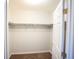 A closet with ample storage, featuring white walls, shelving, and a warm, cozy carpeted floor at 9526 Borough Park St, Las Vegas, NV 89178
