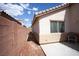 Side exterior view showing the yard, stucco wall, and concrete, which provides a safe and secure space at 9526 Borough Park St, Las Vegas, NV 89178