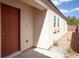 Front exterior featuring a red door with a well kept landscaped entrance at 9526 Borough Park St, Las Vegas, NV 89178