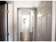 Long hallway featuring neutral walls and tile floors with multiple doorways leading to rooms in the house at 9526 Borough Park St, Las Vegas, NV 89178