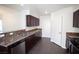 The kitchen is equipped with granite countertops, a stainless steel dishwasher and dark wood cabinets at 9526 Borough Park St, Las Vegas, NV 89178