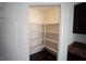 Walk-in pantry with white shelving, maximizing storage in a well-organized kitchen at 9526 Borough Park St, Las Vegas, NV 89178