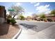 A tranquil street scene in Borough Park neighborhood featuring well-maintained landscaping and clear blue skies at 9526 Borough Park St, Las Vegas, NV 89178