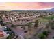 Picturesque aerial of homes bordering a golf course, complete with swimming pool and colorful sky at 9812 Folsom Dr, Las Vegas, NV 89134