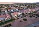 A serene aerial view of a Sun City Summerlin home showcasing the meticulously landscaped backyard and desert surroundings at 9812 Folsom Dr, Las Vegas, NV 89134