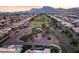Expansive aerial perspective of Sun City Summerlin homes complemented by a golf course and desert landscape at 9812 Folsom Dr, Las Vegas, NV 89134
