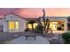Charming backyard featuring desert landscaping and a cozy seating area under the covered patio at 9812 Folsom Dr, Las Vegas, NV 89134