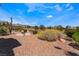 Desert landscaped backyard featuring golf course view and circular seating area at 9812 Folsom Dr, Las Vegas, NV 89134
