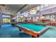 Billiard room with multiple pool tables and natural light from large windows at 9812 Folsom Dr, Las Vegas, NV 89134