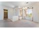 Elegant dining room featuring neutral walls, chandelier lighting, and large window with decorative valances at 9812 Folsom Dr, Las Vegas, NV 89134