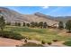 Beautiful golf course and mountain view homes with vibrant green grass at 9812 Folsom Dr, Las Vegas, NV 89134