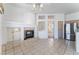 Open-concept living room features tile flooring, fireplace, adjacent kitchen, and seamless flow to outdoor spaces at 9812 Folsom Dr, Las Vegas, NV 89134