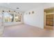 Bright and open living room featuring neutral carpet and view of the outside landscaping at 9812 Folsom Dr, Las Vegas, NV 89134