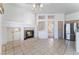 Open-concept living room features tile flooring, fireplace, adjacent kitchen, and seamless flow to outdoor spaces at 9812 Folsom Dr, Las Vegas, NV 89134