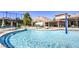 Community outdoor pool featuring a splash fountain, lounge chairs, and covered seating area with mountain views in the background at 9812 Folsom Dr, Las Vegas, NV 89134