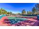 Outdoor tennis courts with mature trees and clear blue skies at 9812 Folsom Dr, Las Vegas, NV 89134