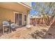 Private backyard patio featuring a barbecue grill, gravel, and sliding glass doors at 9822 Opal Bridge Ct, Las Vegas, NV 89178